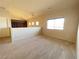 An empty loft space with carpet and neutral colored walls and lots of light at 7633 Winterthur Ct, Las Vegas, NV 89129
