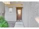 Brown front door with sidelight window and small landscaping at 9135 Hilverson Ave, Las Vegas, NV 89148