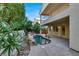 Relaxing kidney-shaped pool with waterfall feature, surrounded by lush landscaping at 9472 Ojibwa Ave, Las Vegas, NV 89149