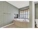 Bathroom with large soaking tub and window at 9472 Ojibwa Ave, Las Vegas, NV 89149