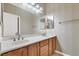 Double vanity bathroom with wood cabinets and neutral decor at 9472 Ojibwa Ave, Las Vegas, NV 89149