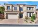 Two-story house with a three-car garage and landscaping at 9472 Ojibwa Ave, Las Vegas, NV 89149