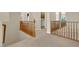 Upstairs hallway with wooden railings and carpeting at 9472 Ojibwa Ave, Las Vegas, NV 89149