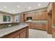 Spacious kitchen with granite countertops and wood cabinets at 9472 Ojibwa Ave, Las Vegas, NV 89149