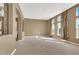 Bright living room with large windows and neutral carpeting at 9472 Ojibwa Ave, Las Vegas, NV 89149