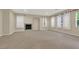 Spacious living room with fireplace and neutral carpeting at 9472 Ojibwa Ave, Las Vegas, NV 89149