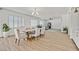 Open concept dining room with hardwood floors and modern chandelier at 9668 Padre Peak Ct, Las Vegas, NV 89178