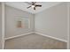 Light-filled bedroom featuring a window with blinds and ceiling fan at 1009 Beaver Crest Ter, Henderson, NV 89015