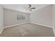 Bright bedroom with carpeted floor, ceiling fan, and window with shutters at 1009 Beaver Crest Ter, Henderson, NV 89015