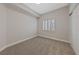 Well-lit bedroom with carpet, window with shutters, and double doors at 1009 Beaver Crest Ter, Henderson, NV 89015