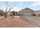 Single-story house with a two-car garage and gravel landscaping at 1009 Beaver Crest Ter, Henderson, NV 89015