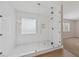 Modern shower with glass enclosure, white tile, and marble floor at 1009 Beaver Crest Ter, Henderson, NV 89015