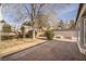 Large backyard with concrete patio, mature trees, and grassy area at 1010 Legacy Dr, Boulder City, NV 89005