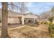 Spacious backyard with covered patio, mature trees, and grassy area at 1010 Legacy Dr, Boulder City, NV 89005