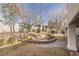 Landscaped backyard with stone pathway, mature trees, and grassy area at 1010 Legacy Dr, Boulder City, NV 89005