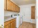 Laundry room with washer, dryer, and wood cabinets at 1010 Legacy Dr, Boulder City, NV 89005