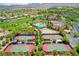 Aerial view of community amenities including tennis courts, pool, clubhouse, and golf course at 10228 Questa Sera Ct, Las Vegas, NV 89135