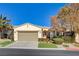 Single-story home with attached garage and landscaped front yard at 10228 Questa Sera Ct, Las Vegas, NV 89135