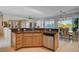 Kitchen island with granite countertops, light wood cabinets, and stainless steel appliances at 10228 Questa Sera Ct, Las Vegas, NV 89135