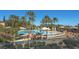 Resort-style pool with palm trees and comfortable lounge chairs at 10228 Questa Sera Ct, Las Vegas, NV 89135