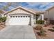 Front view of a single-story house with a two-car garage at 10540 Beachwalk Pl, Las Vegas, NV 89144