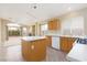 Kitchen with an island, wood cabinets, and tile flooring at 10540 Beachwalk Pl, Las Vegas, NV 89144