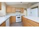 Kitchen with white appliances and wood cabinets at 10540 Beachwalk Pl, Las Vegas, NV 89144