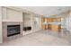 Living room with fireplace and kitchen view at 10540 Beachwalk Pl, Las Vegas, NV 89144