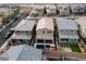 Aerial view of the home with a pool, covered patio, desert landscaping, and community at 10936 White Alder Pl, Las Vegas, NV 89138