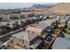 Stunning aerial view of a desert community featuring a backyard pool and mountain views at 10936 White Alder Pl, Las Vegas, NV 89138