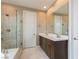 Bathroom boasts double sinks, sleek fixtures, and glass shower with tiled walls at 10936 White Alder Pl, Las Vegas, NV 89138