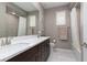 Bathroom featuring double sinks, modern fixtures, and a shower-tub combination at 10936 White Alder Pl, Las Vegas, NV 89138