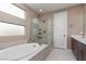 Spa-like bathroom with soaking tub, walk-in shower, and modern fixtures at 10936 White Alder Pl, Las Vegas, NV 89138