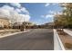 Community entrance gate with stone accents and desert landscaping at 10936 White Alder Pl, Las Vegas, NV 89138