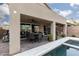 Covered patio with outdoor dining, ceiling fan, barbecue area, and pool at 10936 White Alder Pl, Las Vegas, NV 89138