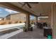 Covered patio with ceiling fans, outdoor dining area, and view of the pool at 10936 White Alder Pl, Las Vegas, NV 89138