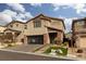 Inviting two-story home with modern design, glass garage door, and professionally landscaped front yard at 10936 White Alder Pl, Las Vegas, NV 89138