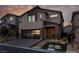 Modern two-story home with sleek glass garage door and desert landscaping at 10936 White Alder Pl, Las Vegas, NV 89138