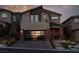 Two-story home with modern facade, attached garage, and landscaped yard at 10936 White Alder Pl, Las Vegas, NV 89138