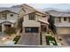 Front view of the two-story home featuring modern design, desert landscaping, and mountain views at 10936 White Alder Pl, Las Vegas, NV 89138