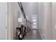 Bright foyer features a modern console table and a staircase with a black metal railing at 10936 White Alder Pl, Las Vegas, NV 89138