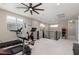 Open game room area with exercise equipment and an arcade game at 10936 White Alder Pl, Las Vegas, NV 89138