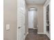 Hallway with hardwood floors, neutral paint, and a view of the front door and an archway at 10936 White Alder Pl, Las Vegas, NV 89138