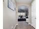 Open hallway leading to a living area with sliding glass doors and contemporary furnishings at 10936 White Alder Pl, Las Vegas, NV 89138