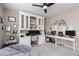 Bright home office with built-in shelving and dual computer stations at 10936 White Alder Pl, Las Vegas, NV 89138