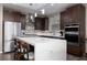 Modern kitchen with stainless steel appliances and an island at 10936 White Alder Pl, Las Vegas, NV 89138