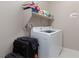 Clean laundry room with washer, dryer, and overhead shelving at 10936 White Alder Pl, Las Vegas, NV 89138