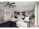 Stylish living room features a comfortable sectional sofa and views into the modern kitchen and dining area at 10936 White Alder Pl, Las Vegas, NV 89138