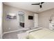 Bright main bedroom featuring an en-suite bathroom and a modern ceiling fan at 10936 White Alder Pl, Las Vegas, NV 89138