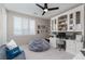 Home office with built-in shelving and a comfy beanbag chair at 10936 White Alder Pl, Las Vegas, NV 89138